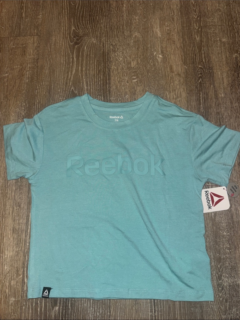 Girl Reebok Light Teal Embossed Logo Cropped Tee
